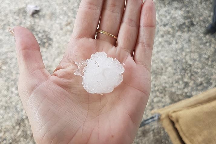 A piece of hail in the palm of a hand at Gleneagle.