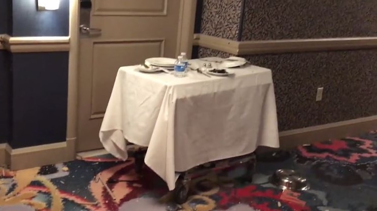 A photo from outside Paddock's hotel room shows a room service cart with a camera under a plate.