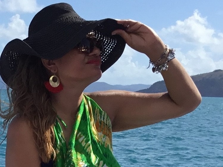 Indigenous woman on boat looking out to sea.