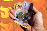 Hand holding Australian money with red dirt below and illustrated flames for a story about helping with bushfire appeals.