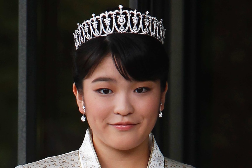 Japanese Princess Mako wears a silver formal dress with a diamond tiara crown and diamond teardrop flower earrings.