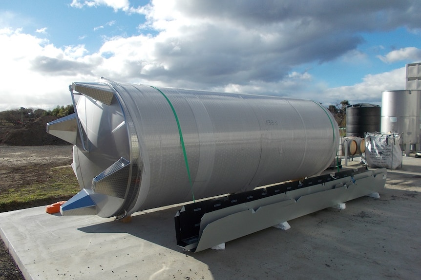 A big stainless steel tank laying on it side.
