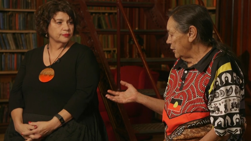Yuwullarai woman Kirstie Parker  and Kokotha Elder Sue Haseldine facing each other in a library setting