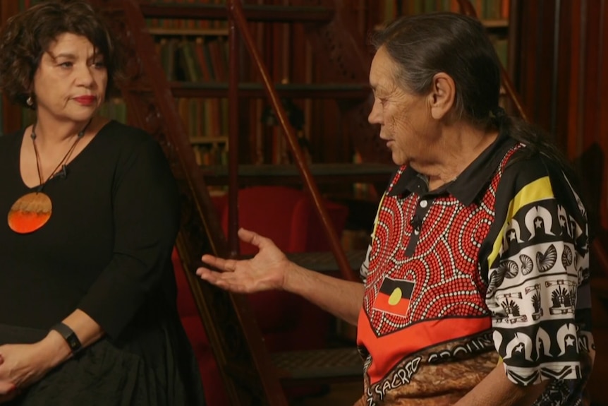 Yuwullarai woman Kirstie Parker  and Kokotha Elder Sue Haseldine facing each other in a library setting