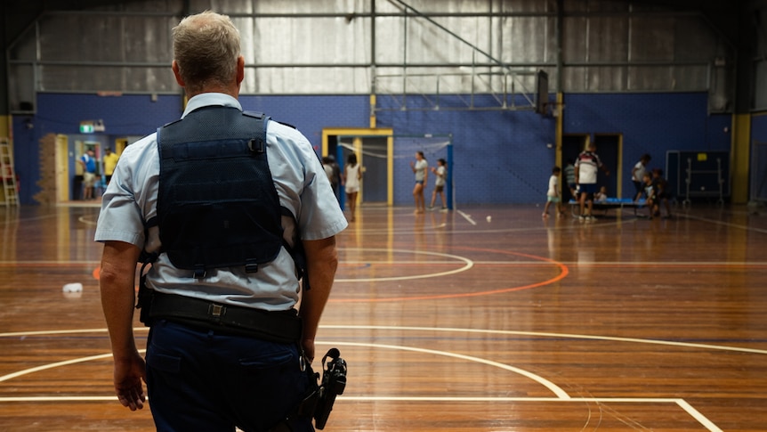 A Moree police officer playing goaltender at the PCYC hall