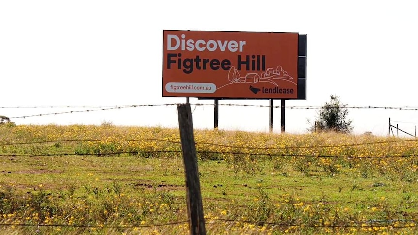 Lendlease-branded billboard mounted in country landscape says 'Discover Figtree Hill'.