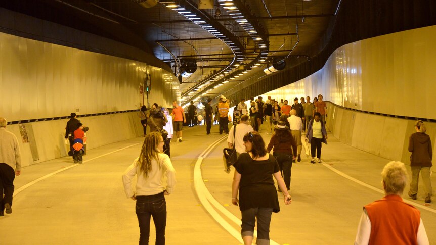 People walk through Northern Busway tunnel between the Lutwyche and Kedron Park bus stations.