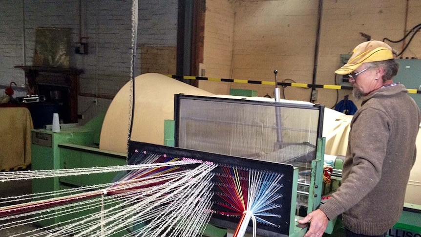 Worker operates machine at Launceston's Waverley Woollen Mill