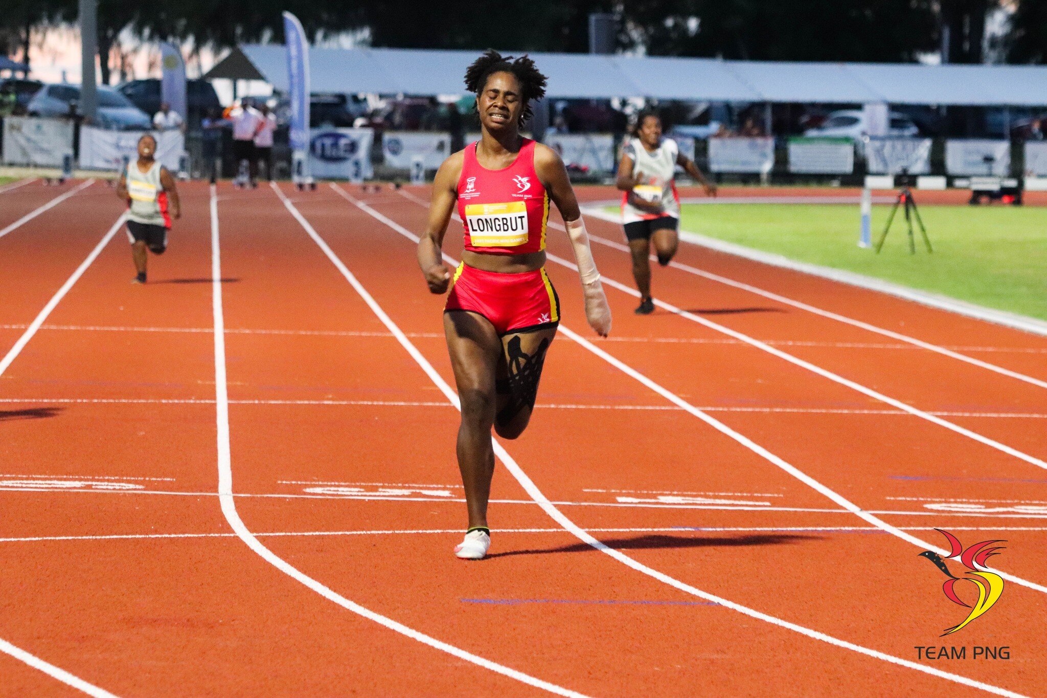 Para-athlete Dorna Longbut crosses the finish line first in a 100m race.