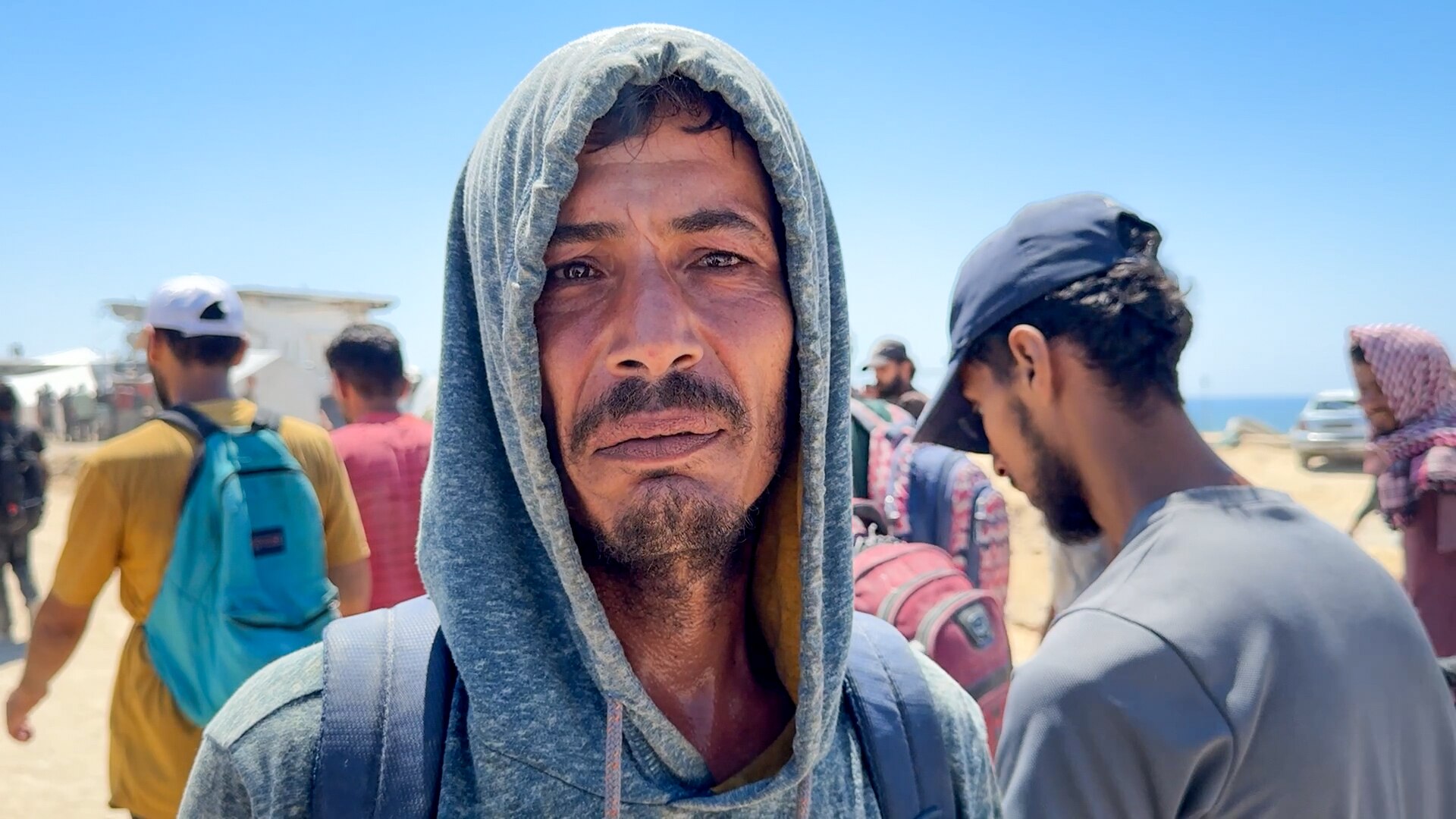 A Palestinian man wearing a hoodie, looking at the camera.