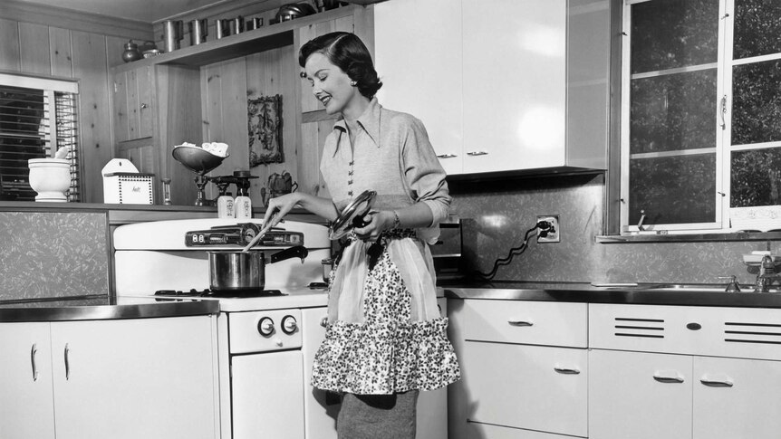 1950's image of woman cooking at the stove
