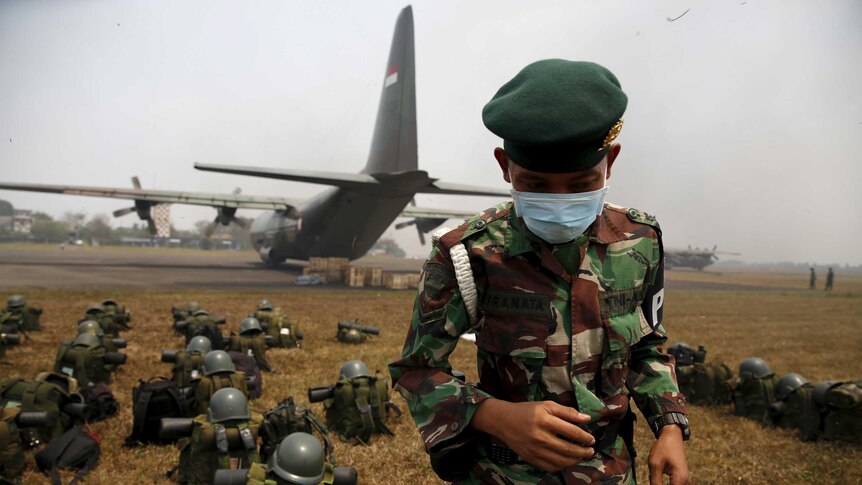 Indonesian soldiers arrive at Talang Betutu airport in Palembang to reinforce firefighter teams