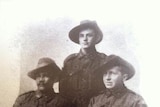 William Williams sits in uniform for a portrait with two other servicemen