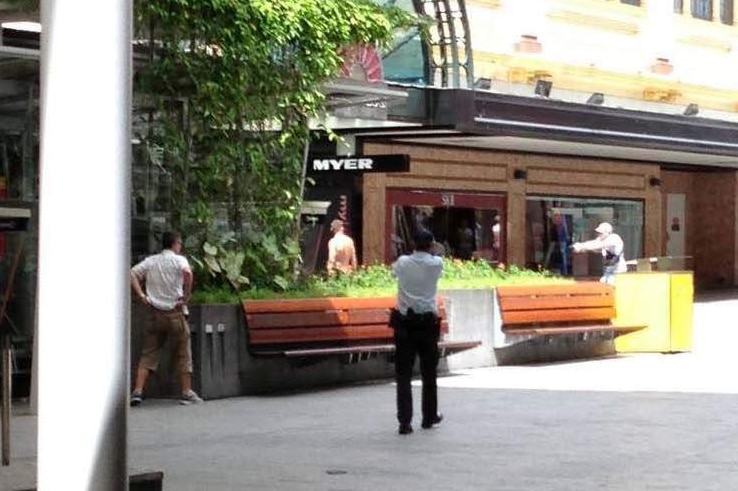 Police surround a shirtless gunman in Brisbane's Queen Street Mall