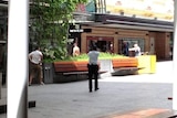 Police surround a shirtless gunman in Brisbane's Queen Street Mall