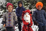 Three kids and a snowman.