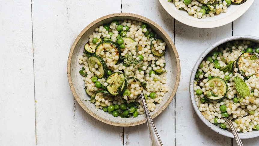 Three bowls of charred zucchini and pearl couscous salad