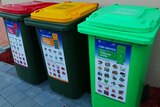 A red bin, a yellow bin and a green bin