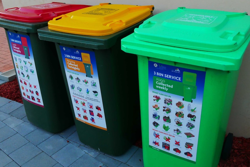 A red bin, a yellow bin and a green bin