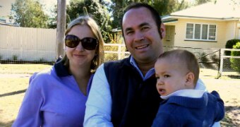 A family in front of a house.