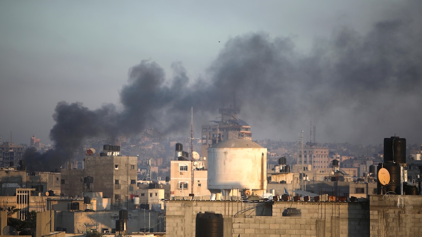 Smoke rises from town of Khan Younis after Israeli strikes on Friday, Dec. 15