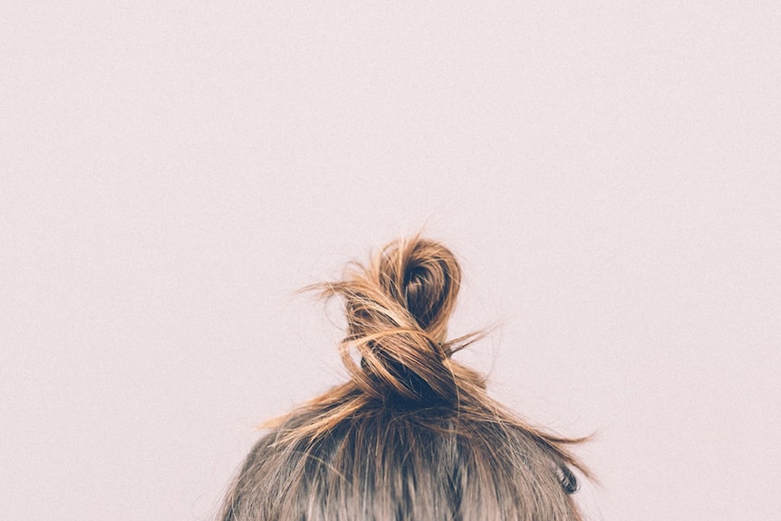 A woman's hair tied up in a bun.