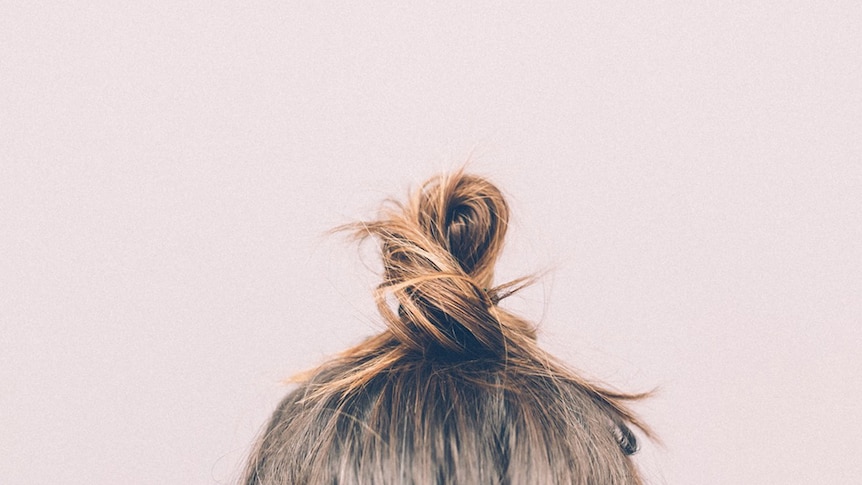 A woman's hair tied up in a bun.