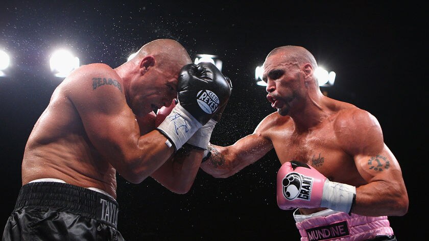 Anthony Mundine lands some chin music on Shannan Taylor.