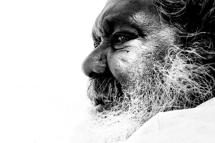 Black and white extreme close up of a senior Kaiadilt man looking into the distance