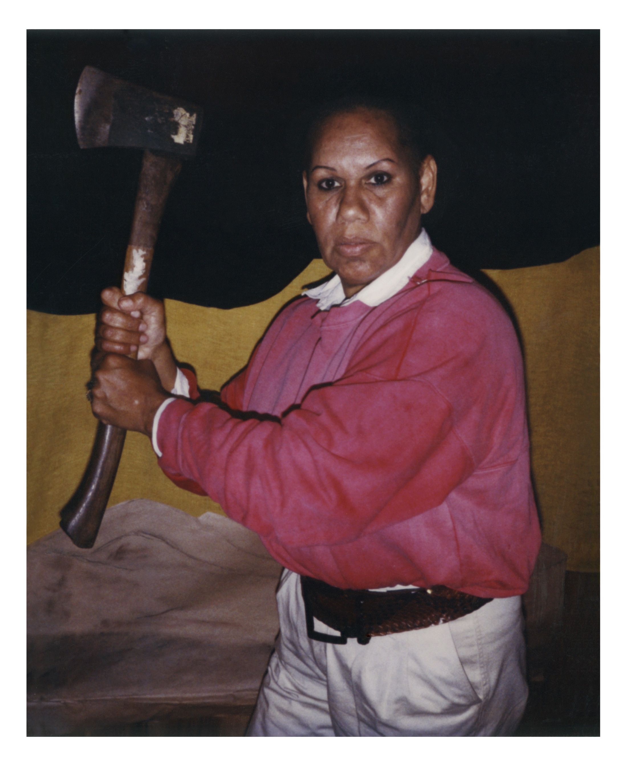 A 90s photograph of the Aboriginal writer Eva Johnson wielding an axe