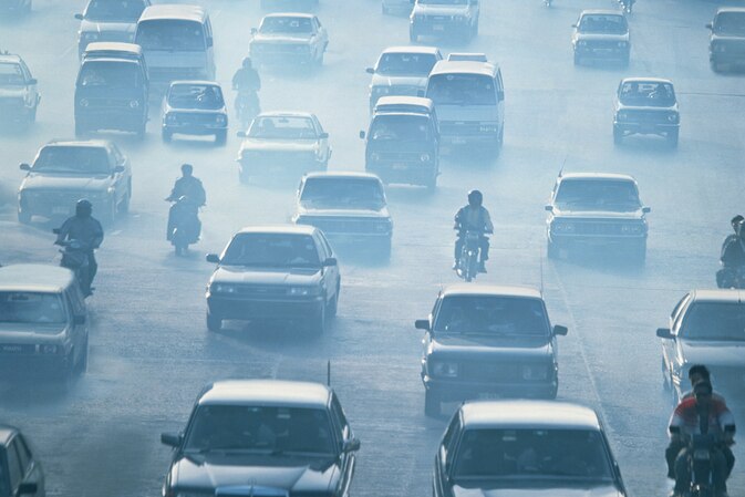 Traffic and smog on a road in Bangkok.