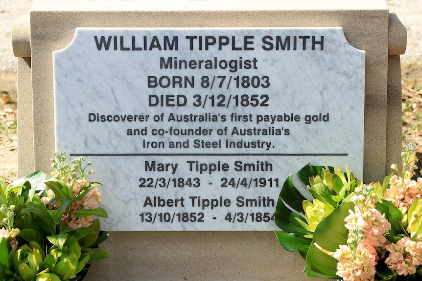 A headstone of William Tipple Smith with flowers.