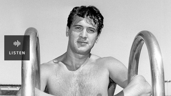 black and white image of American star Rock Hudson coming out of a swimming pool, wearing black trunks. Has Audio.