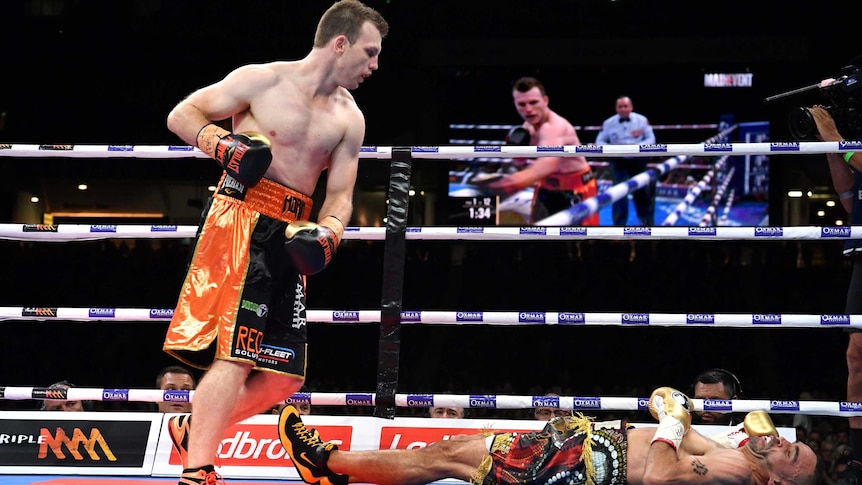 Jeff Horn looks over Anthony Mundine on the canvas