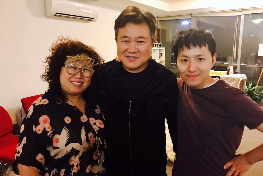 Bang in shot with his father and stepmother in the living room for new years eve dinner.