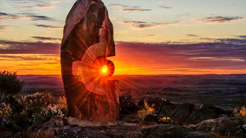 Rays of sun hit stone sculpture