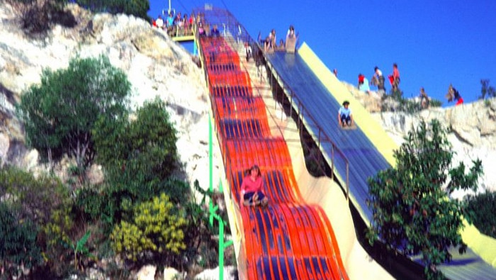 Kids use a slide at Magic Mountain, Gold Coast, in the 1980s