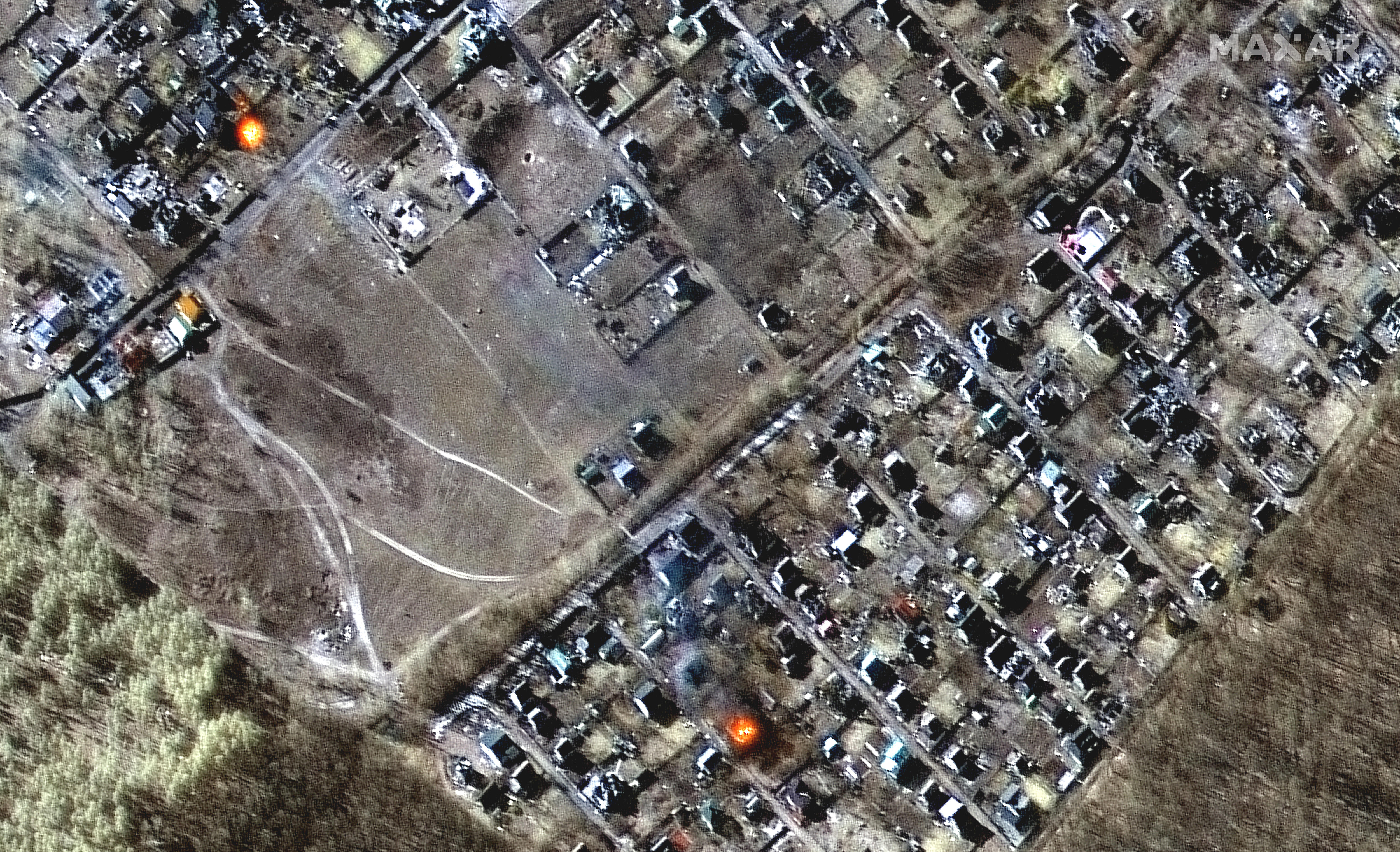 Satellite images show burning houses and Russian forces deploying closer to Kyiv