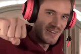 Swedish Youtube star PewDiePie wearing bright headphones.