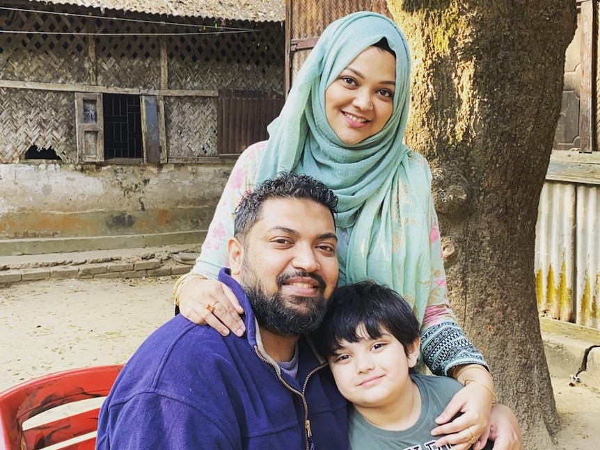 Hansanul Bunna Khan with his wife Tashfia and son Nayel pose for a picture by a tree