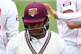 A Queensland Sheffield Shield batter leaves the field after being dismissed by South Australia.