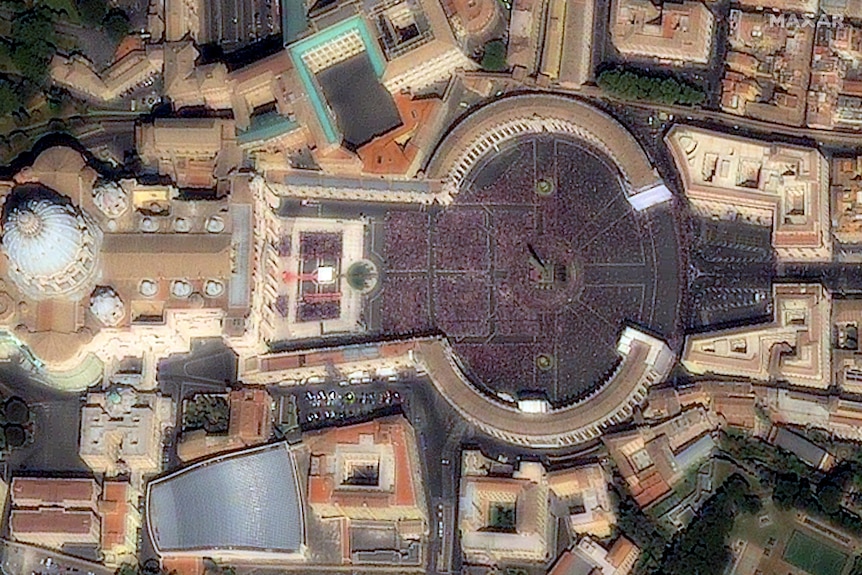 A satellite image shows St Peter's Square in Rome filled with hundreds of people