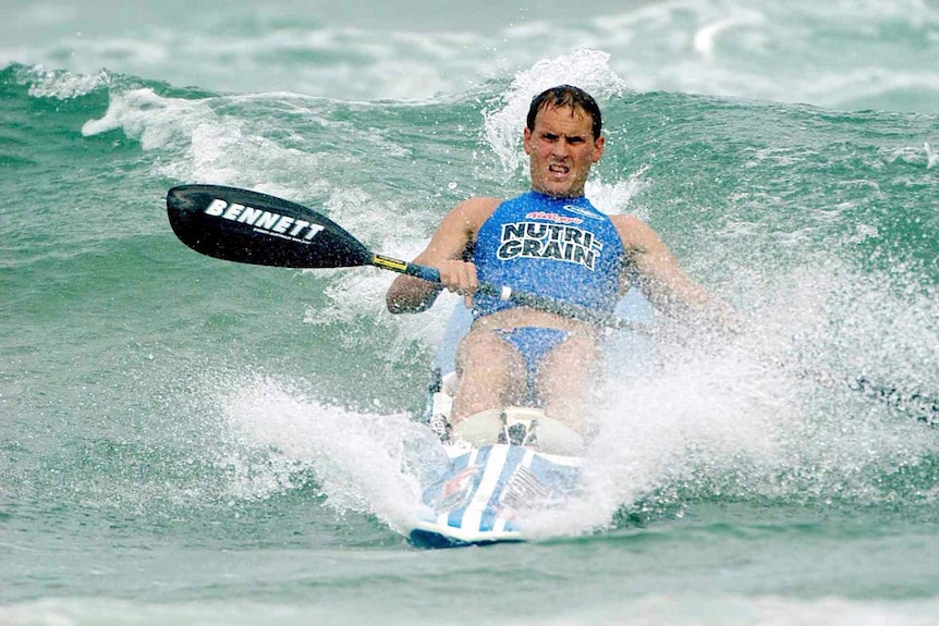 Ironman Dean Mercer in the waves on a surf ski at Main Beach on the Gold Coast in December 2003.