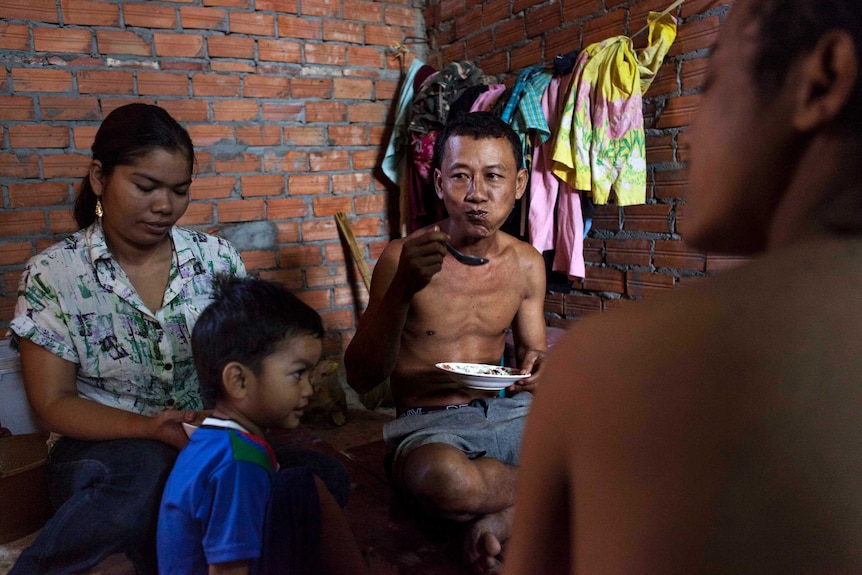 42-year-old Kim Sarith eats breakfast with his family.