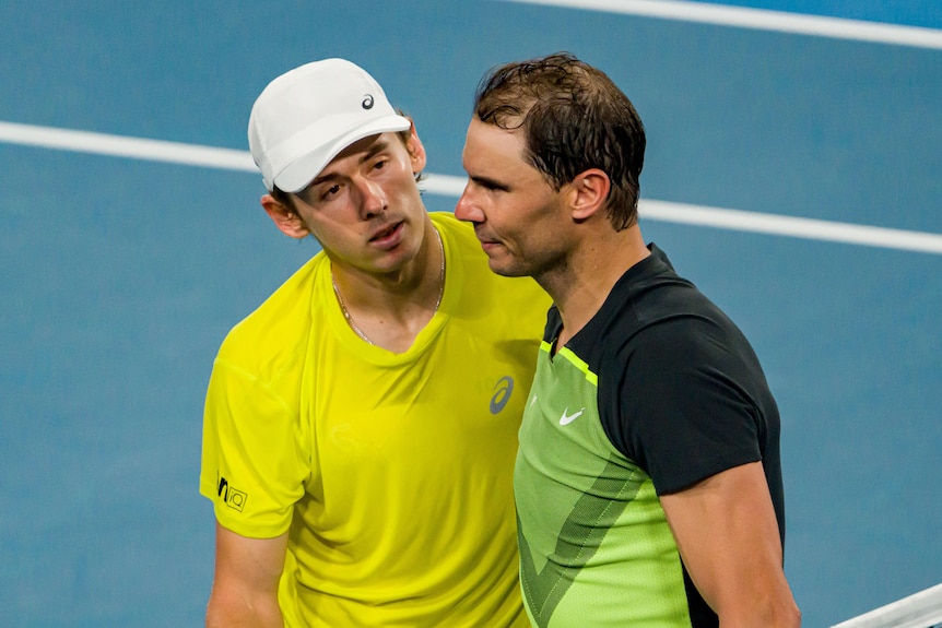 Alex de Minaur consoles Rafael Nadal at the net after a United Cup tennis match.
