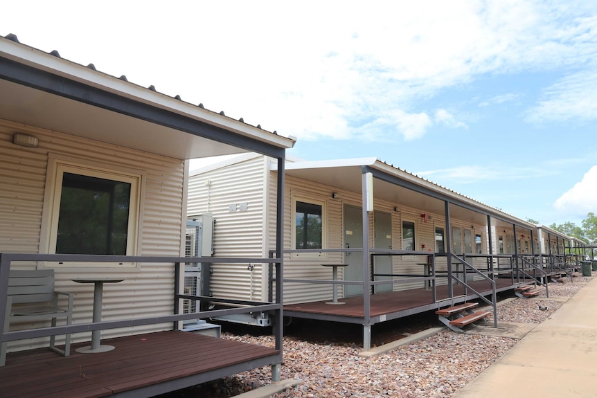 A photo of the Howard Springs quarantine facility, showing a row of dongas each with a small verandah out the front.