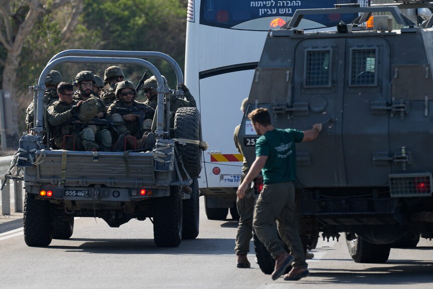 Israeli soldiers in military trucks.