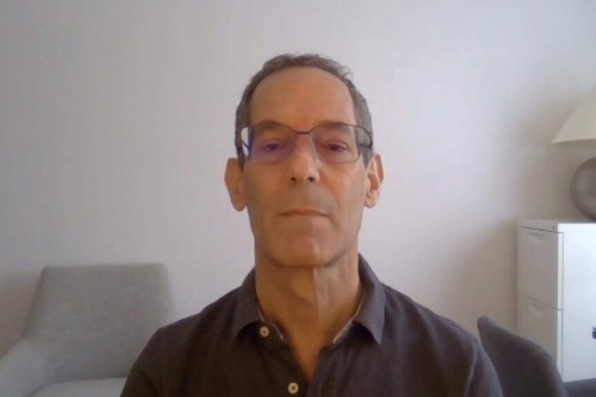 MCU of Paul Kershaw doing a Skype interview wearing glasses and a grey collared shirt