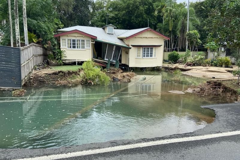 A home nearly split in two by flooding at Holloways Beach. 