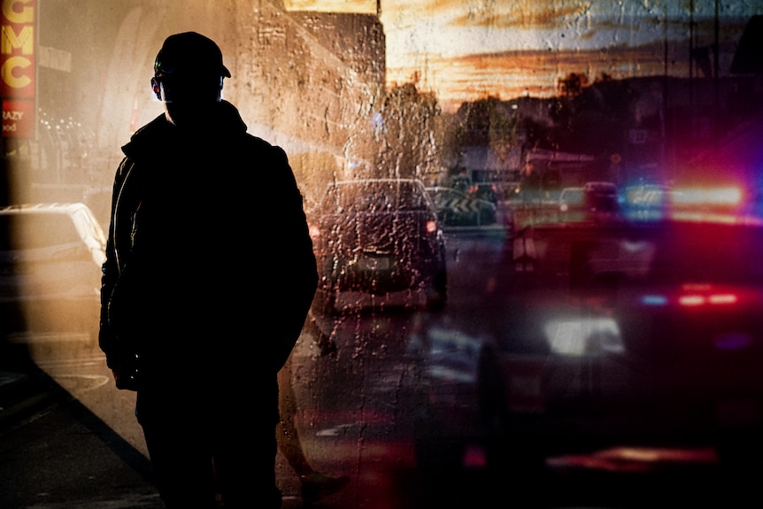 Graphic with silhouette of police officer next to flashing police cars 
